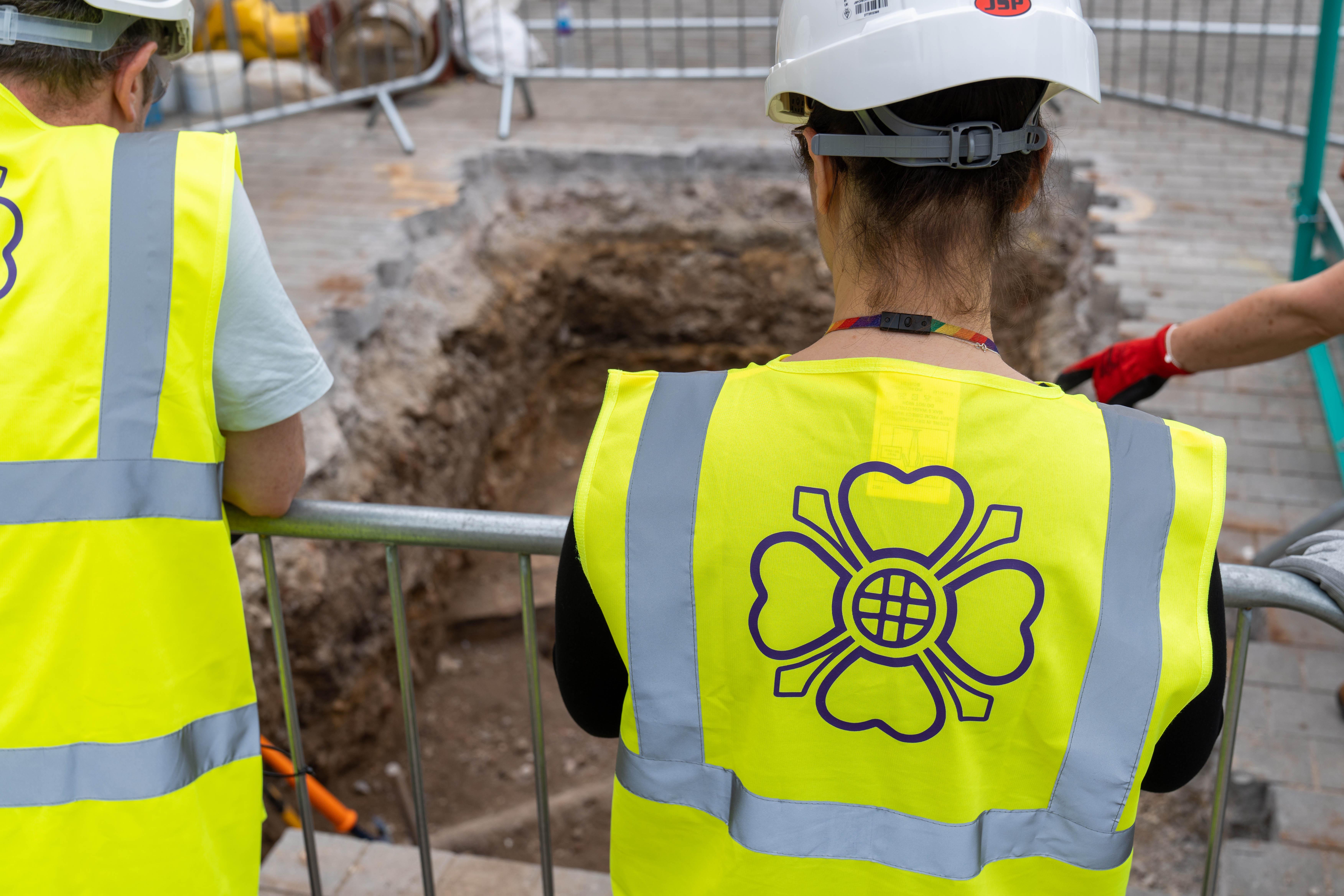 Archaeologists observing the substantial remains of the medieval Lesser Hall.