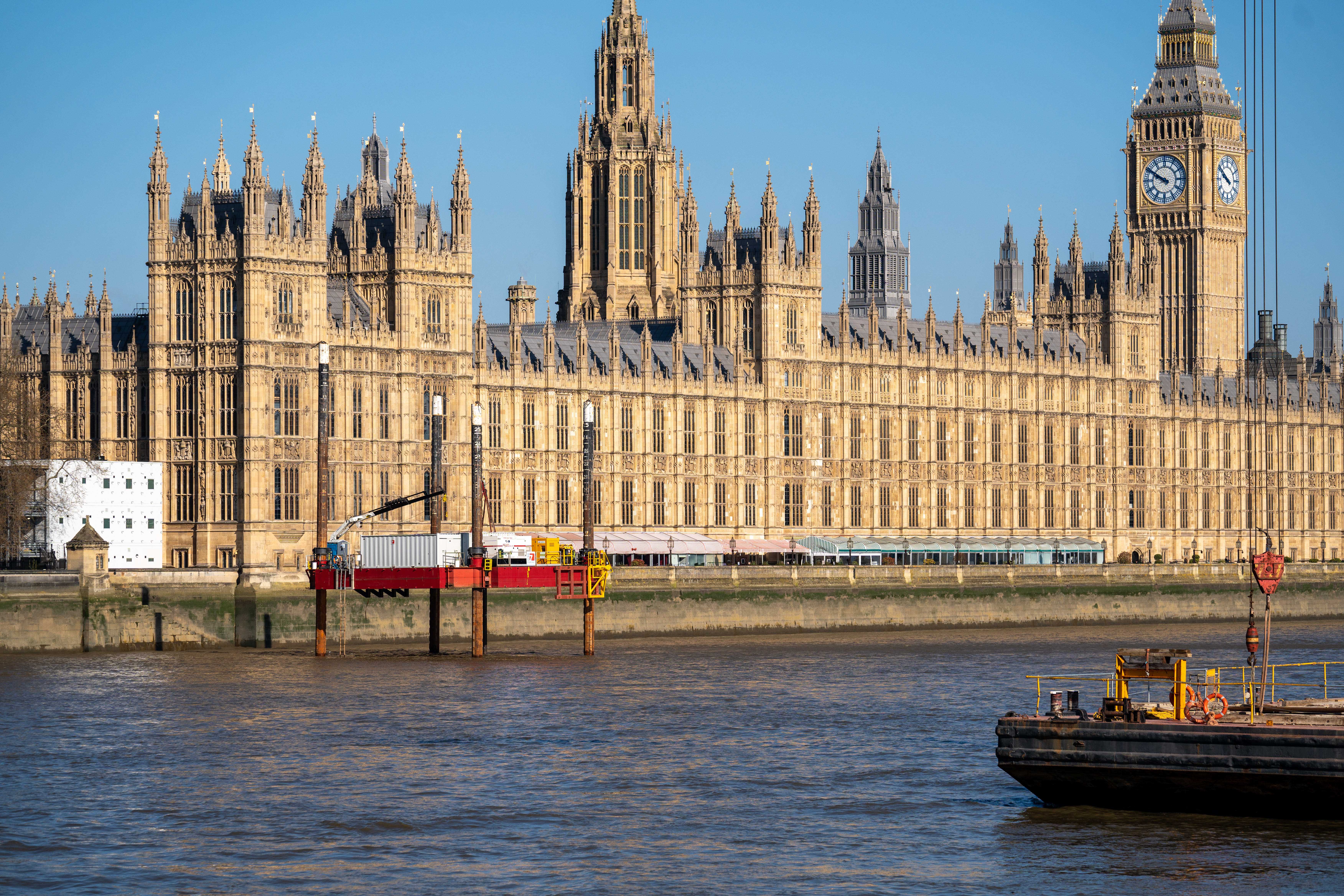 A jack-up barge stationed on the River Thames enables drilling investigations beside the Palace of Westminster