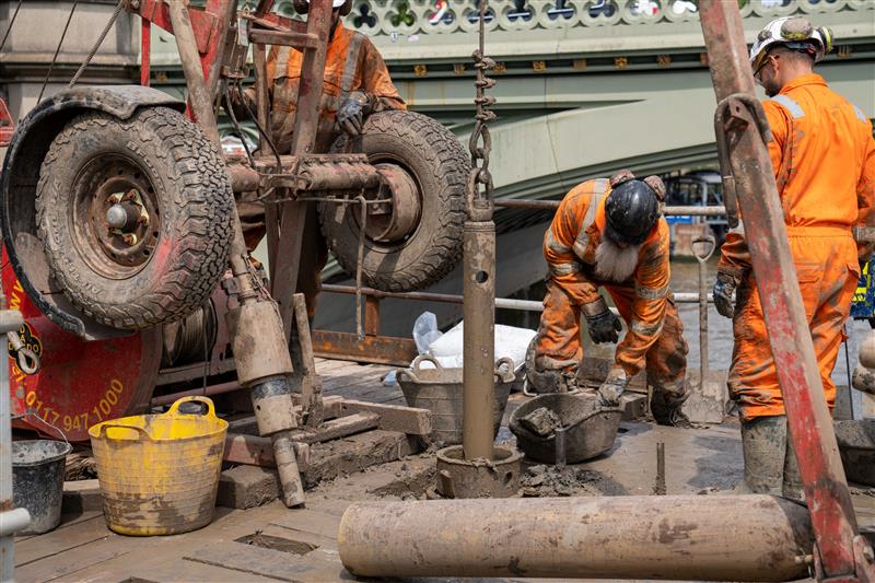 Engineers conduct overwater drilling beside the Palace of Westminster using a jack-up barge on the River Thames