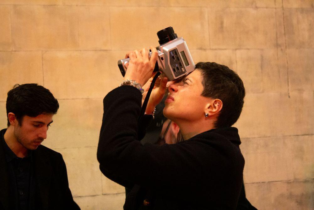 A tourist points a camera at the ceiling