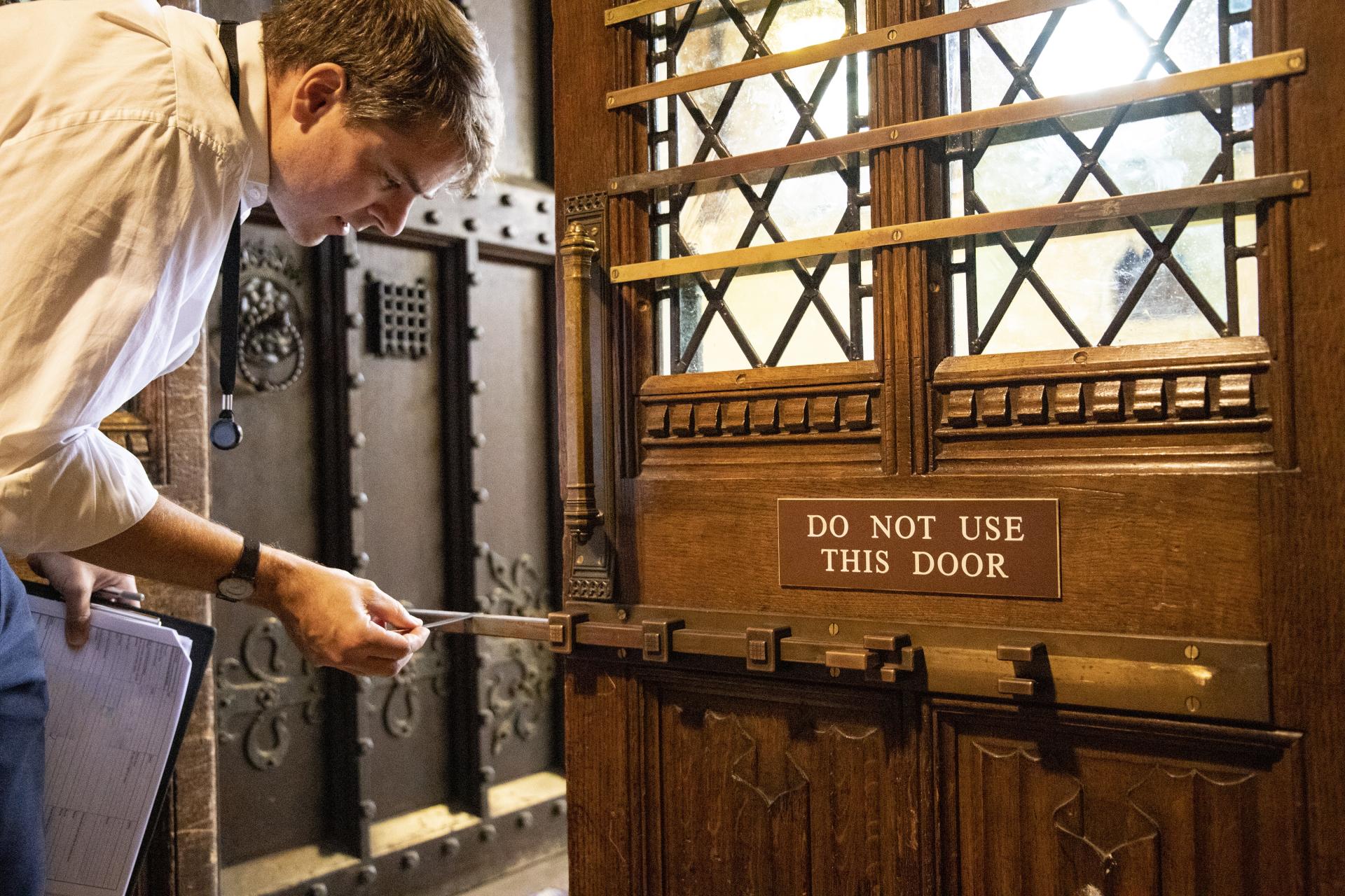 A worker inspects a door