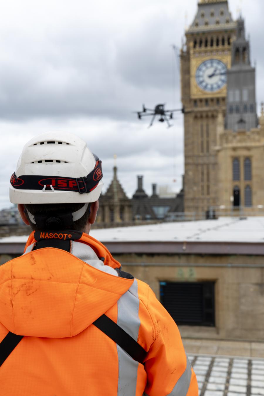 Man in hi-vis operating a drone